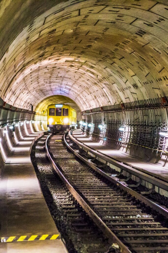 Dramatic view of a Berlin subway tunnel with train approaching, showcasing modern infrastructure.